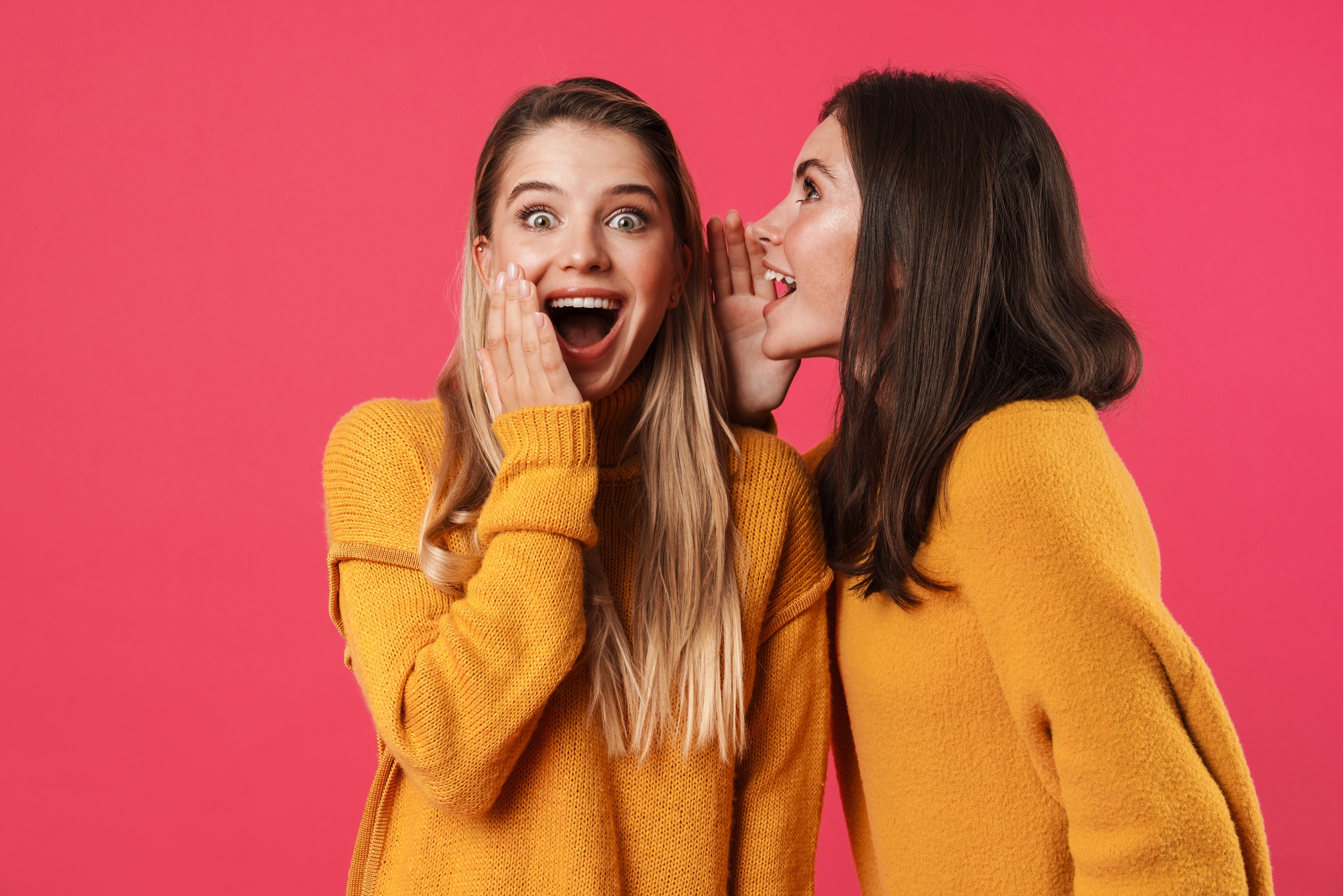 Image of Beautiful Woman Whispering Secret to Her Excited Friend